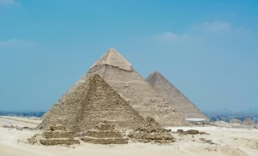 A stunning view of the Great Pyramids of Giza against a clear blue sky in Egypt.